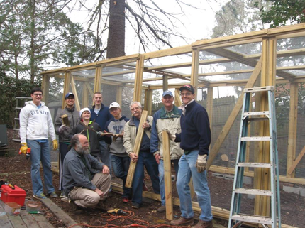volunteers building 24 foot cage